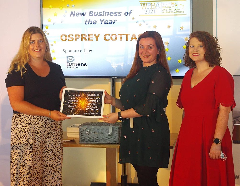 Philippa Snell from Osprey Holiday Cottages receiving the award alongside the category sponsor