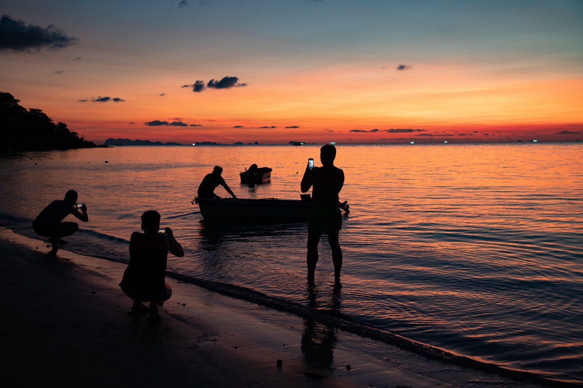 People taking pictures on a holiday, in the sunset